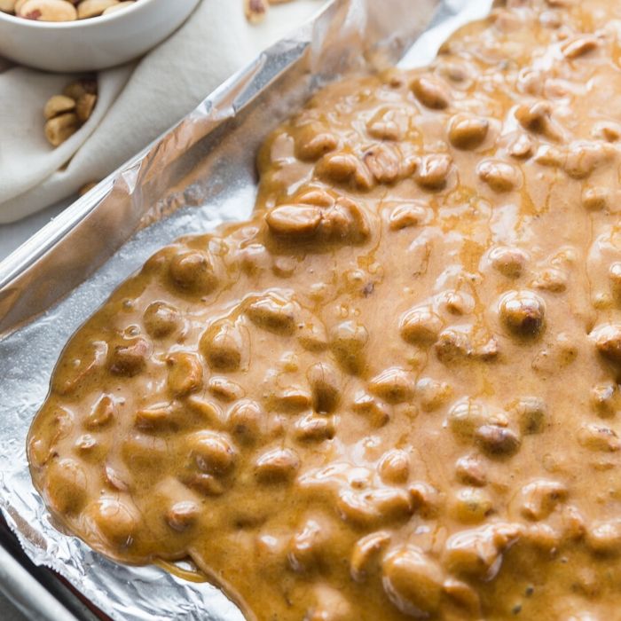 Peanut brittle is a classic holiday treat. Make this microwave peanut brittle today! Just a few ingredients, quick cook time, and a tasty Christmas recipe. #christmas #peanutbrittle #easy #microwave #rawpeanuts #cornsyrup #holiday #recipe easy peanut brittle