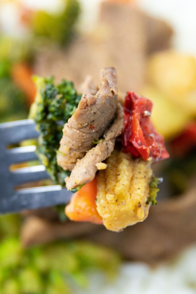 fork with meat and veggies on it 