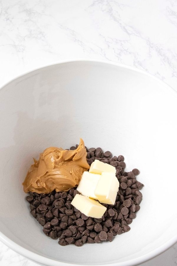 chocolate, peanut butter, and butter in a white bowl 