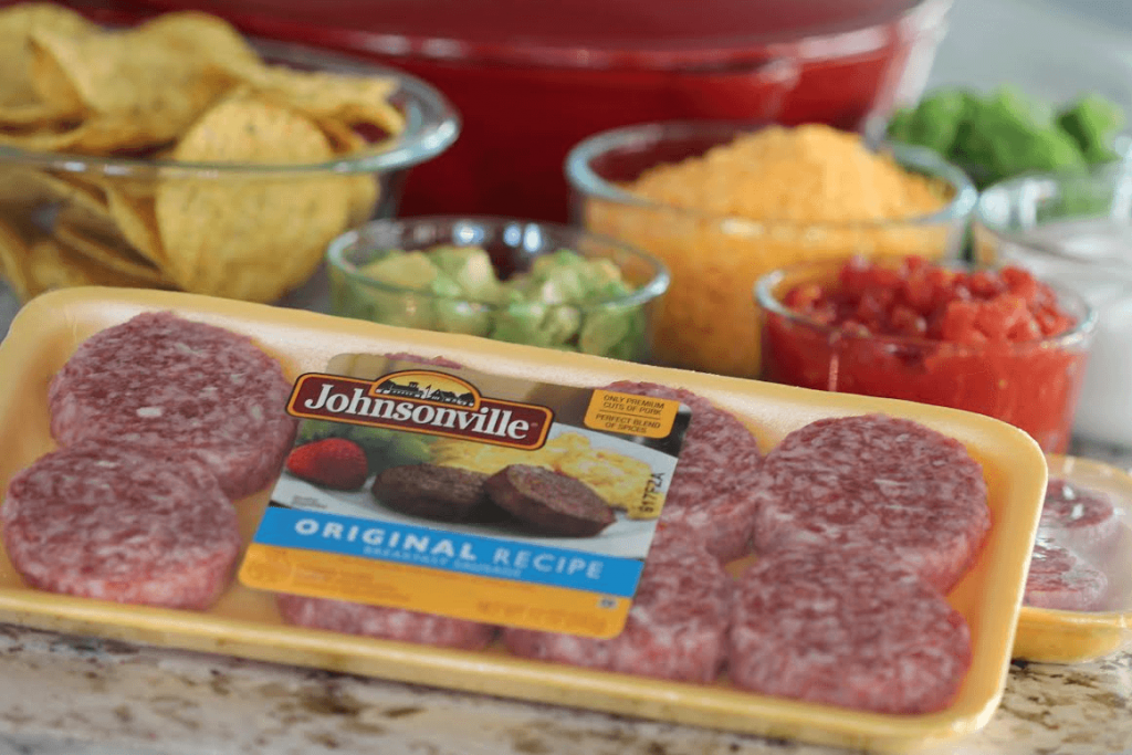 Wow your friends with this spicy game day nachos recipe. This nacho recipe is so easy to make, and loaded with all your favorite toppings. #nachos #skillet #appetizer #sausage #recipe #gameday #food #snacking #party #easy #loaded Johnsonville Sausage a