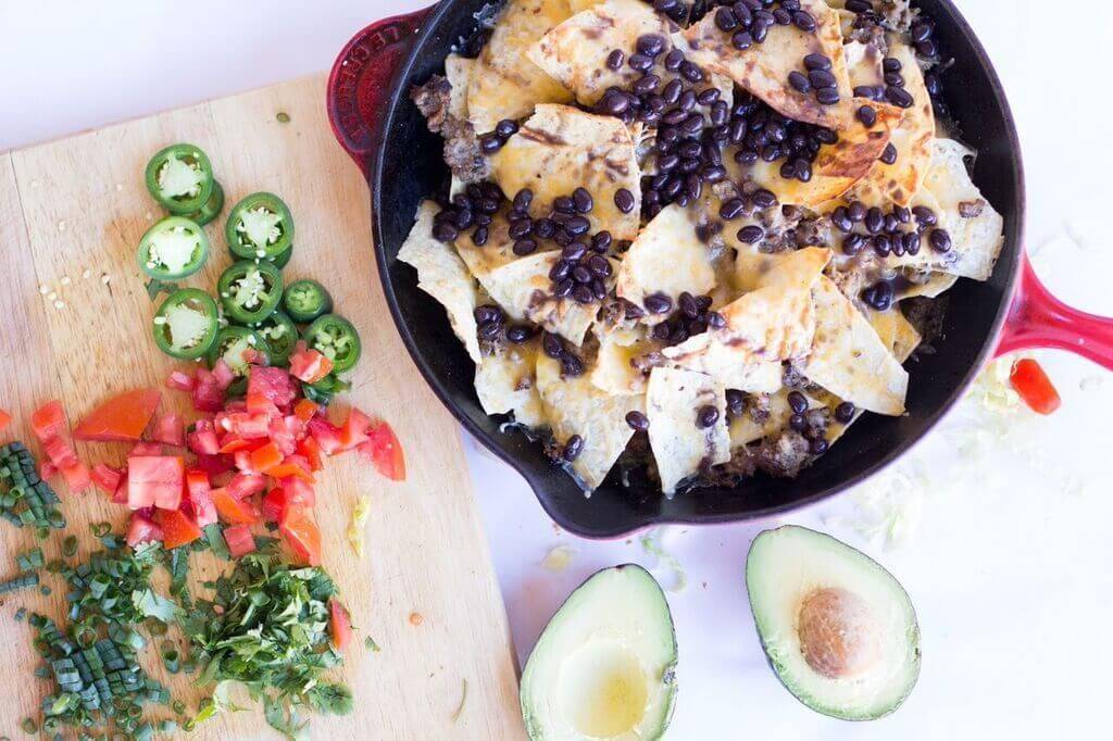 Wow your friends with this spicy game day nachos recipe. This nacho recipe is so easy to make, and loaded with all your favorite toppings. #nachos #skillet #appetizer #sausage #recipe #gameday #food #snacking #party #easy #loaded Spicy Game Day Nachos4