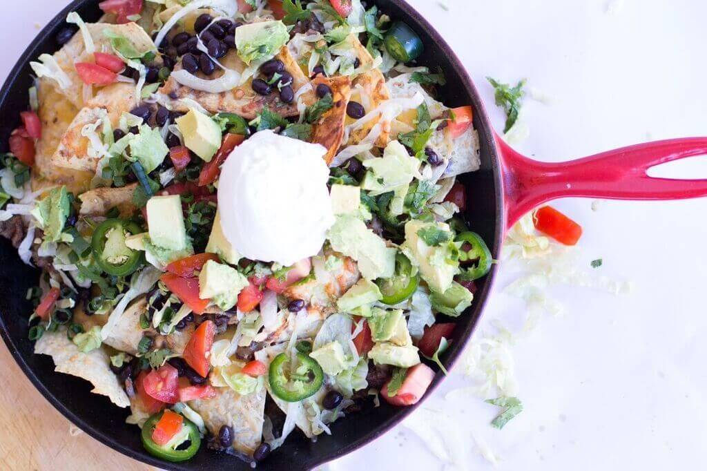 Wow your friends with this spicy game day nachos recipe. This nacho recipe is so easy to make, and loaded with all your favorite toppings. #nachos #skillet #appetizer #sausage #recipe #gameday #food #snacking #party #easy #loaded Spicy Game Day Nachos6