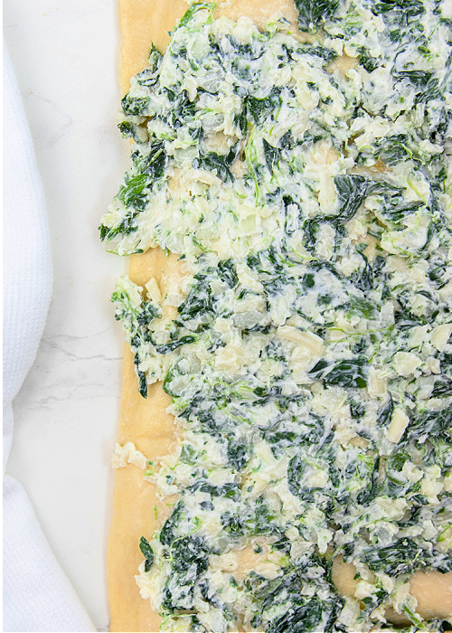 Spinach filling spread on puff pastry