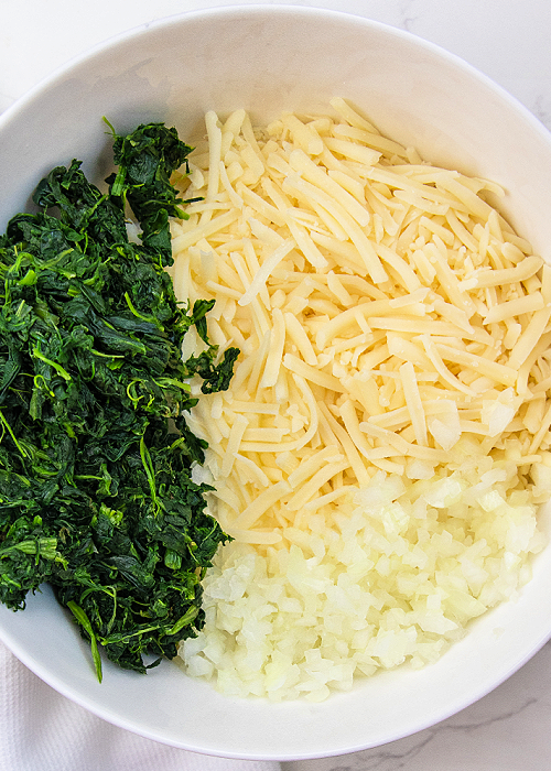 ingredients for creamy spinach rollups in a bowl