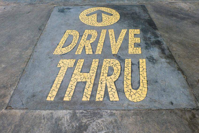 32165854 - thailand - september 04, 2014: mcdonalds logo drive thru. it is the world's largest fast food chain, over 31,000 restaurants worldwide, serve 58 million customers each day