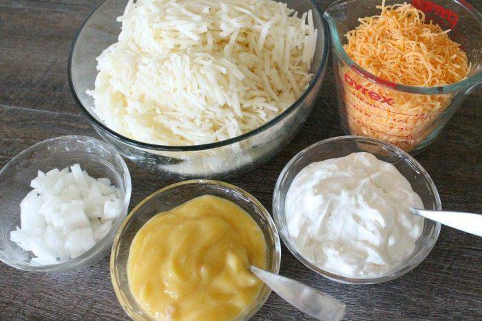 This Cracker Barrel Hash Brown Casserole Recipe is delicious and amazing so be sure to give it a try! Cheesy Hashbrowns that are baked to perfection. #hashbrown #easy #copycat #crackerbarrel #potluckside #potatorecipe #baked #cheesy #sidedishrecipe ingredients in bowl for hash brown casserole recipe