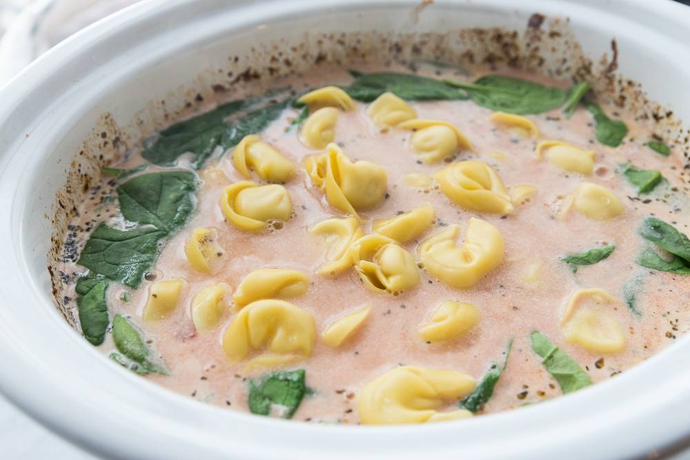 Learn how to make this savory and delicious slow cooker Tuscan tortellini soup recipe. An easy slow cooker soup that the whole family will love #slowcooker #crockpot #soup #tortellinisoup #easytortellinisouprecipe #slowcookersoup #easyweeknightmeal how to make tortellini soup