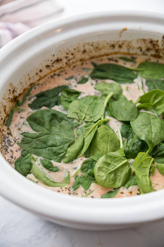 Learn how to make this savory and delicious slow cooker Tuscan tortellini soup recipe. An easy slow cooker soup that the whole family will love #slowcooker #crockpot #soup #tortellinisoup #easytortellinisouprecipe #slowcookersoup #easyweeknightmeal tuscan tortellini soup in process