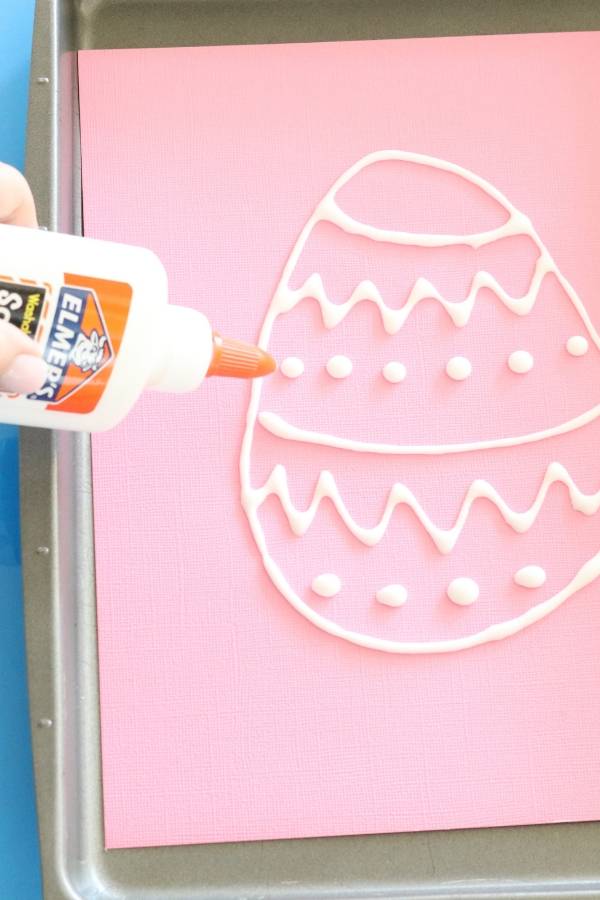 EASY Easter Egg Salt Painting craft for kids to make this Easter. Colorful, bright, and simple to make with minimal supplies needed. #saltpainting #craft #kids #easy #paint #foodcoloring #salt #glue #affordable easter egg salt painting craft