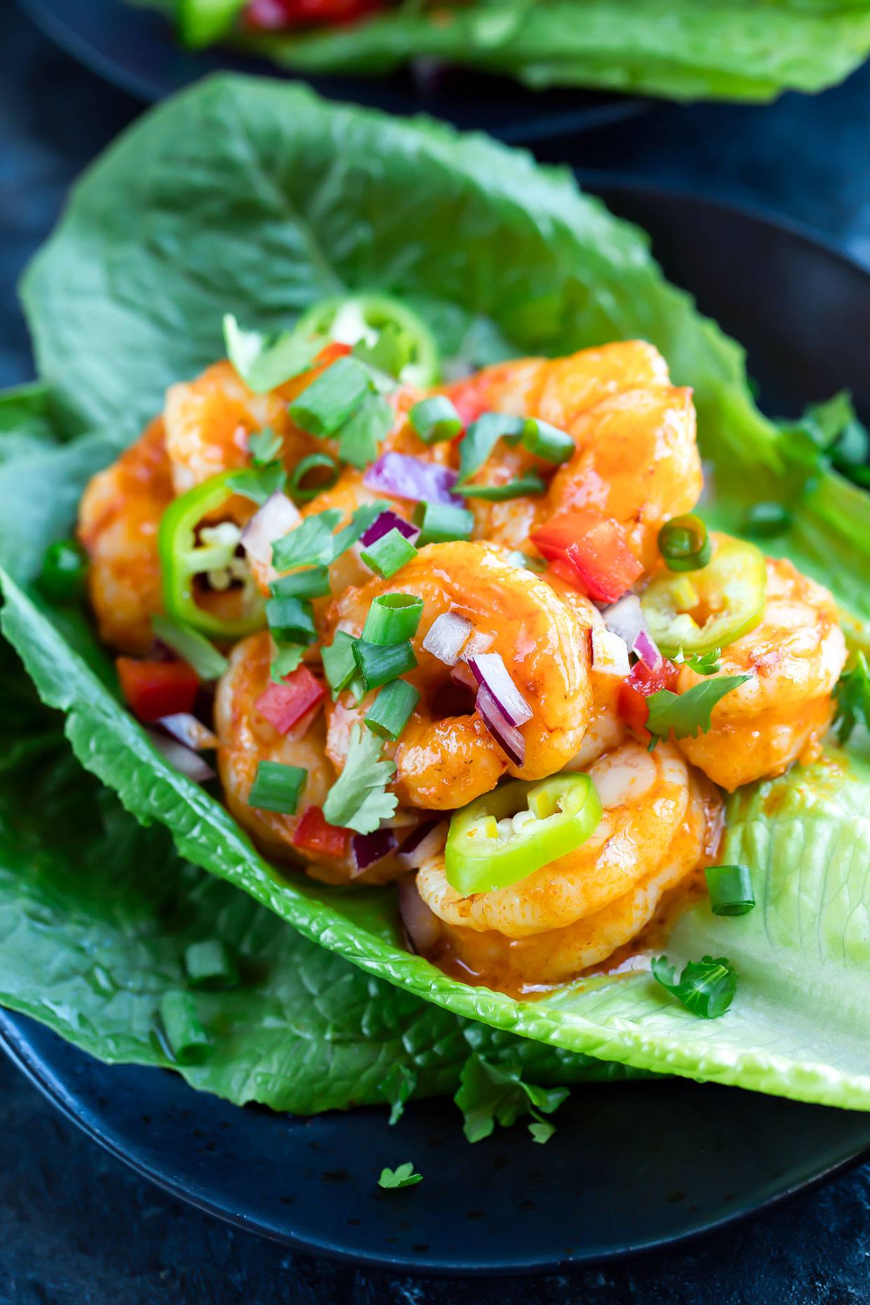 buffalo shrimp lettuce wrap on a plate 