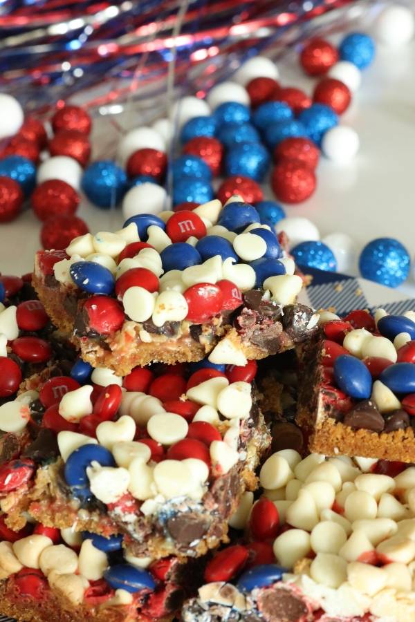 4th of July Magic Cookie Bars are one simple patriotic dessert. Layers of ingredients bake up into chewy and sweet cookie bars. #patriotic #4thofJuly #dessert #magicbars #cookiebars #easydessert #summerdessert magic cookie bar variations