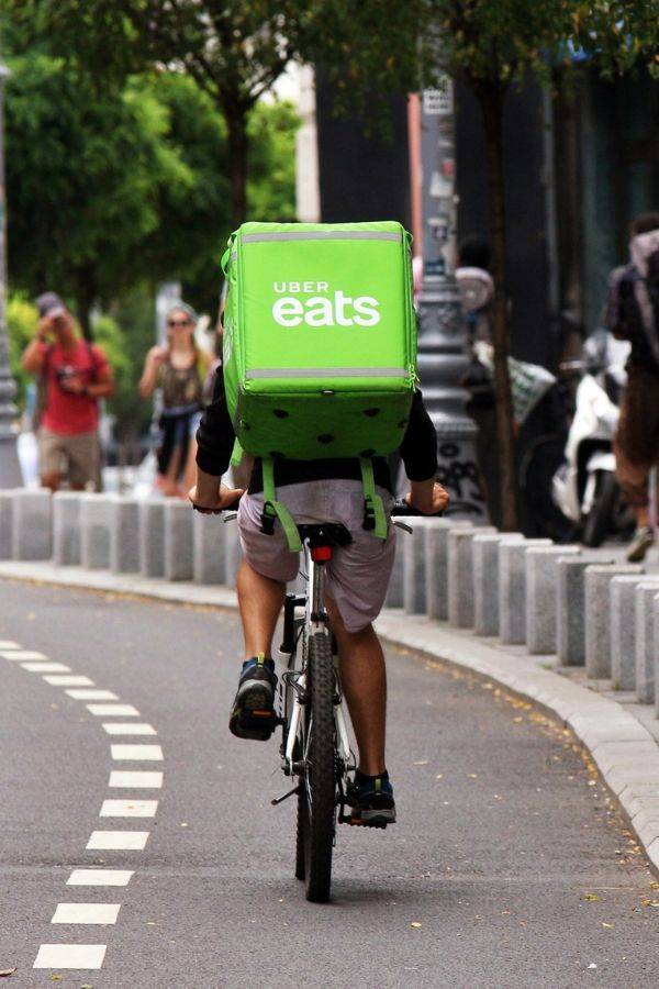 uber eats biker riding on street