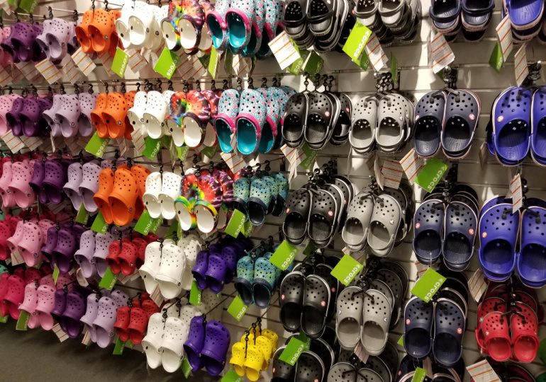 Croc Deals - The Best Croc Deals - Numerous Croc Shoes displayed on wall