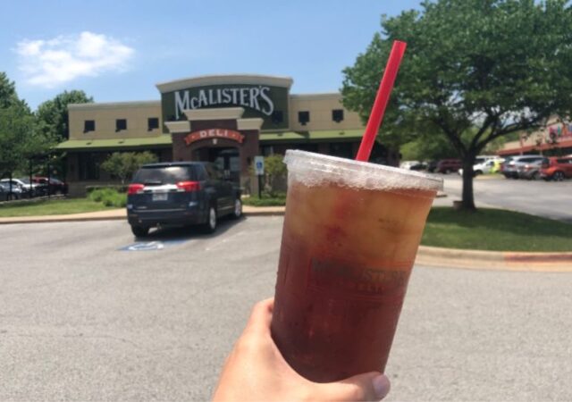 McAlister's Deli Free Tea Day - holding tea in front of mcalister's deli