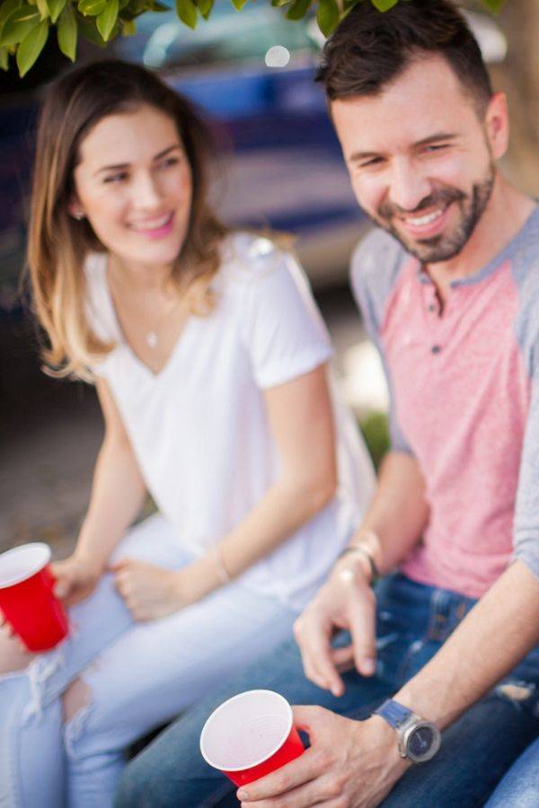 people sitting down holding solo cups