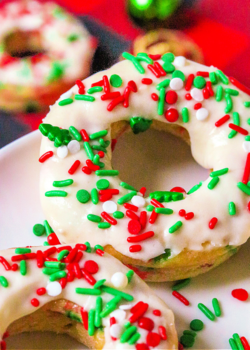 baked christmas confetti donuts on a serving platter