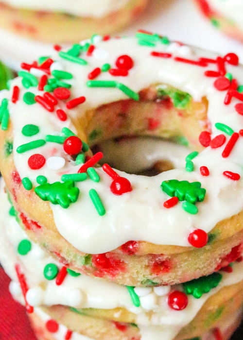 a close up of the glaze on christmas confetti donuts