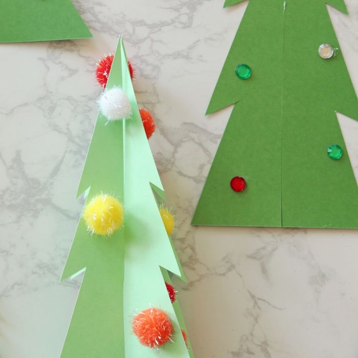 Scrapbook Papper Christmas Trees are so easy to make and the perfect craft for kids this holiday season. Give this Christmas craft a try. #Christmas #craft #diy #project #paper #scrapbook #howtomake tree craft