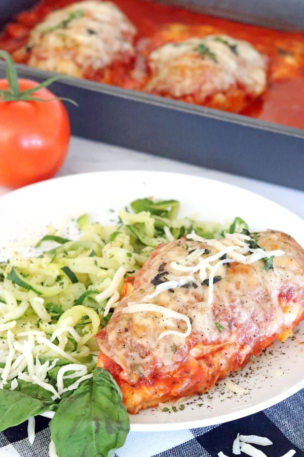 Low Carb Chicken Parmesan is an easy and satisfying weeknight meal. Chicken parmesan in the oven is a super simple way to get the meal you know and love. #chicken #parmesan #lowcarb #baked #easy #oven #chicken #breast #sugarfree #mozzarella chicken parmesan