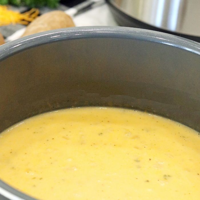 Instant Pot Cheesy Potato Soup is a quick and easy way to get dinner on the table in a hurry. Tender potatoes, cheesy base and loads of flavor. #potato #soup #instantpot #pressurecooker #souprecipe #easy #quick #frozenpotatoes #dinner #recipe #mealtime instant pot soup