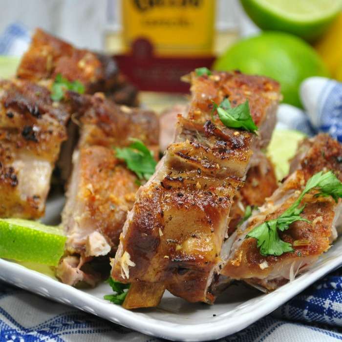 ribs on a plate topped with herbs