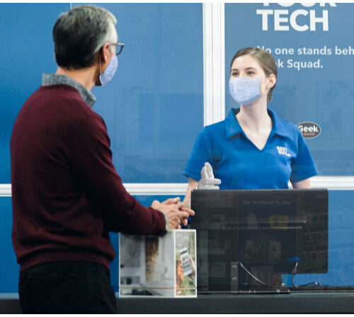 Stores Requiring Face Mask - Best Buy Associate Helping a customer 