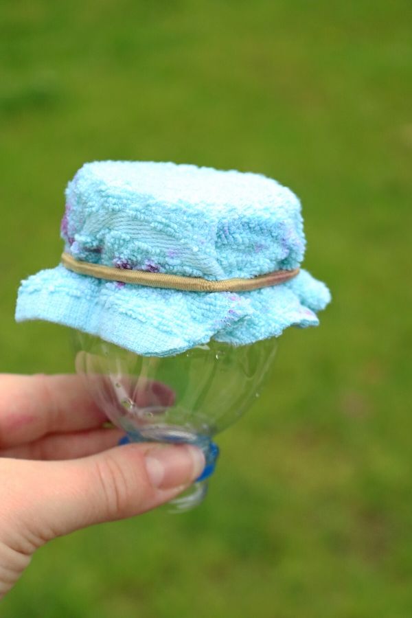 bottle water cut with washcloth over the top