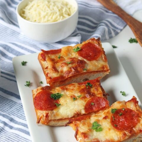 french bread pizza on a white platter