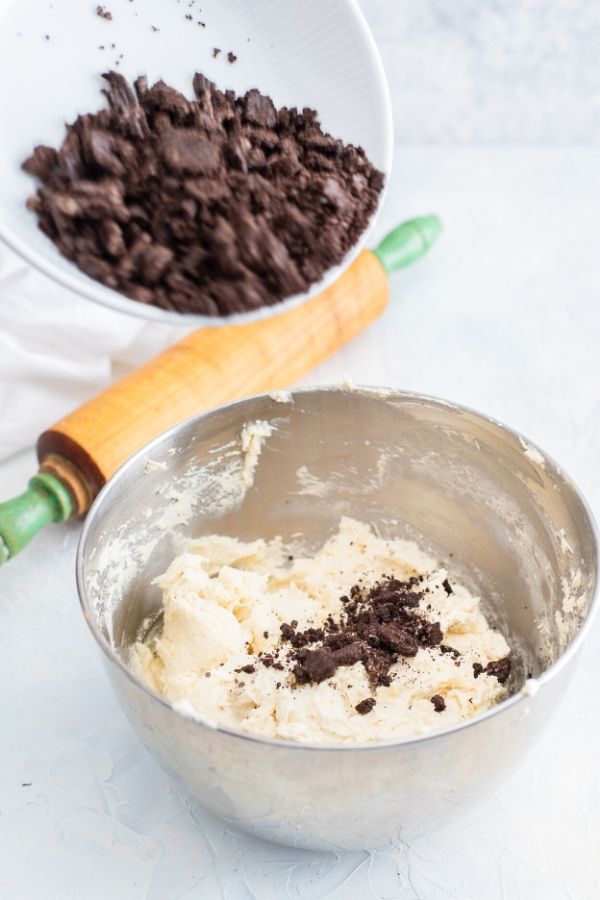 Cookies and Cream Cookies are the ultimate cookie recipe for cookie lovers! If you love Hershey's cookie and cream candy bar, you will love these cookies. #cookies #cookiesandcream #dessert #oreo #creamcheese #bakesale #cookieswap #dessertrecipe cream cheese cookie dough in a bowl