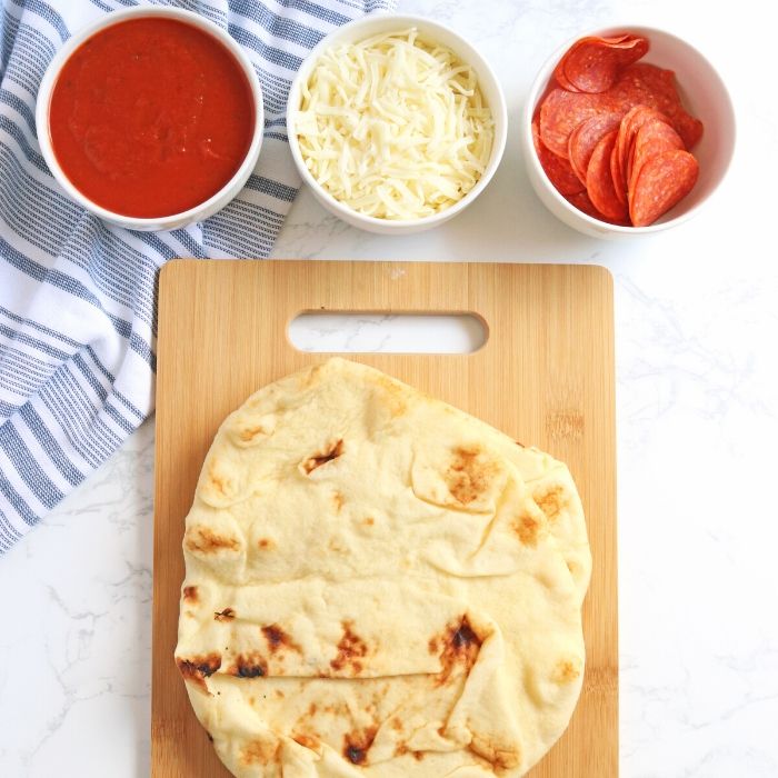 Flat Bread Pizza is the easiest weeknight flatbread pizza recipe. Whip this up for a quick and easy 20 minute dinner the whole family will enjoy. #passion4savings #pizza #flatbread #naan #pepperoni #easy #20minute #dinner #familyfriendly ingredients for flat bread pizza