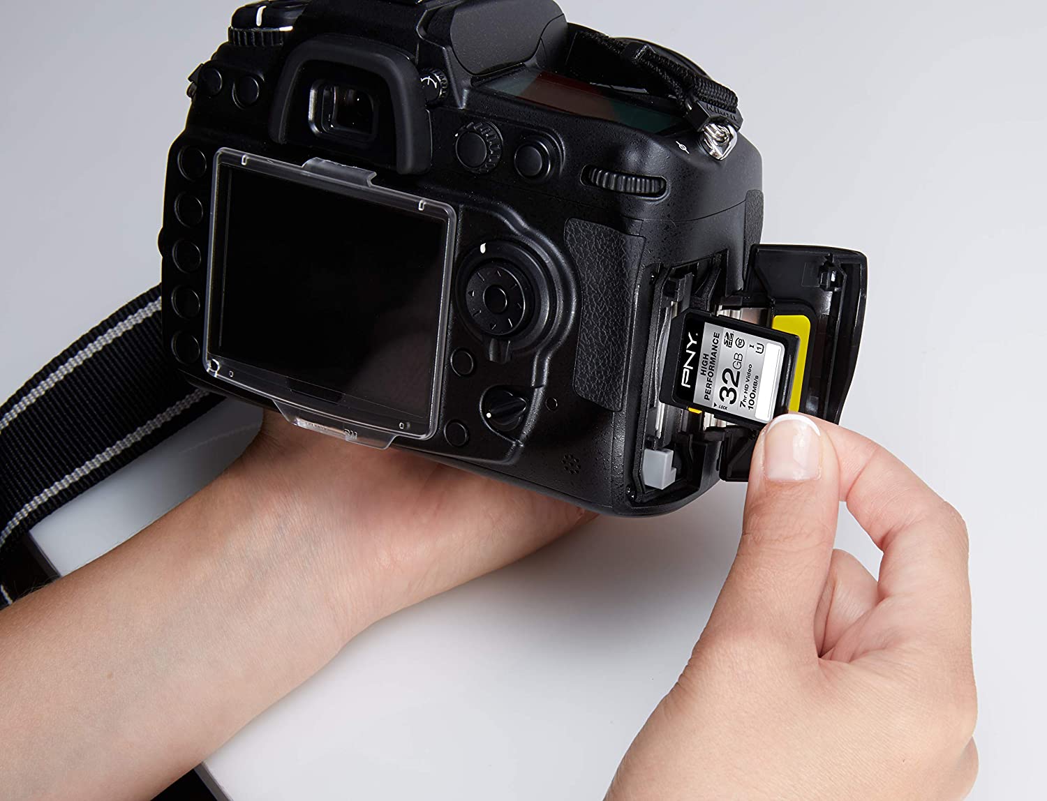 Memory Cards on Sale - person putting memory card in camera