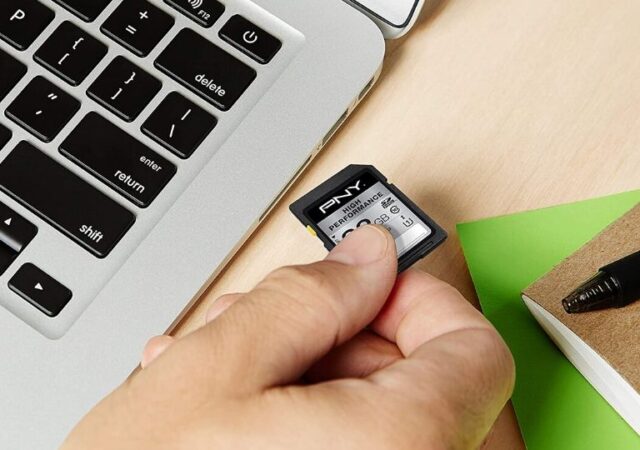 Memory Cards on Sale - person putting memory card in computer