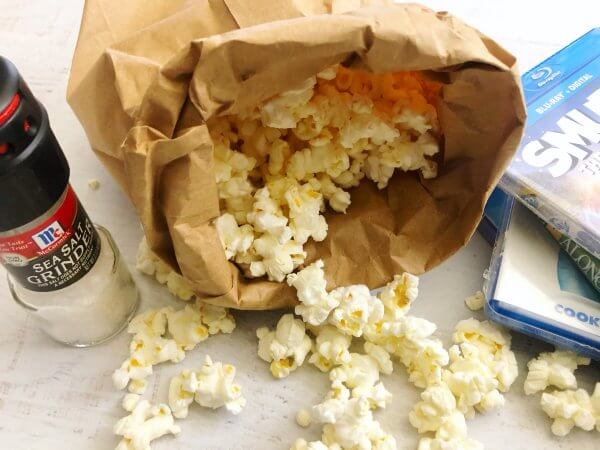 popcorn in a bag with salt by it 