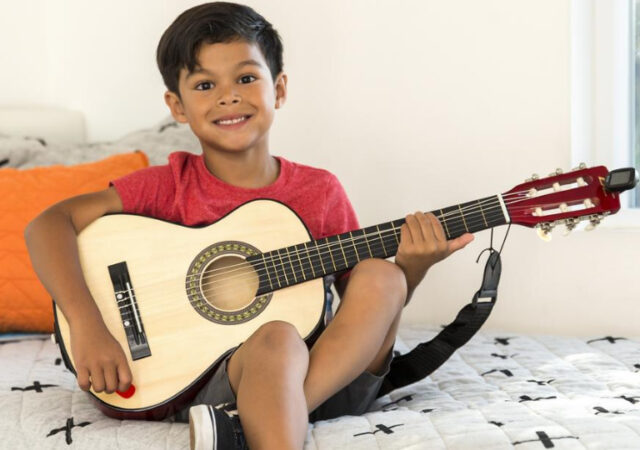 Kid's Acoustic Guitar on Sale - Young Boy Playing Acoustic Guitar