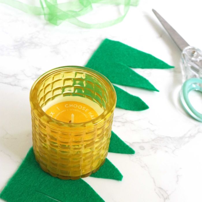 Make this easy pineapple candle as a gift idea to give to a loved one, neighbor or even a back to school teachers gift! A Dollar Tree craft that is easy! #passion4savings #pineapple #craft #candle #gift #easy #freeprintable #dollartree #dollarstore #summer felt cut wiht candle on it