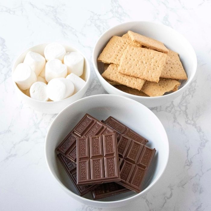 Microwave S'Mores allows you to eat a classic s'mores any time of the year. Rain, shine, snow, or whatever it may be, stay inside and use your microwave to make a s'mores. #passion4savings #smores #easy #dessert #nobake #homemade #forkids #indoor #grahamcracker #Hershey's #marshmallow graham cracker dessert