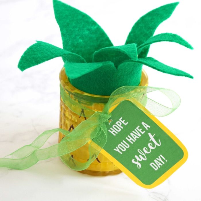 Make this easy pineapple candle as a gift idea to give to a loved one, neighbor or even a back to school teachers gift! A Dollar Tree craft that is easy! #passion4savings #pineapple #craft #candle #gift #easy #freeprintable #dollartree #dollarstore #summer pineapple candle on table