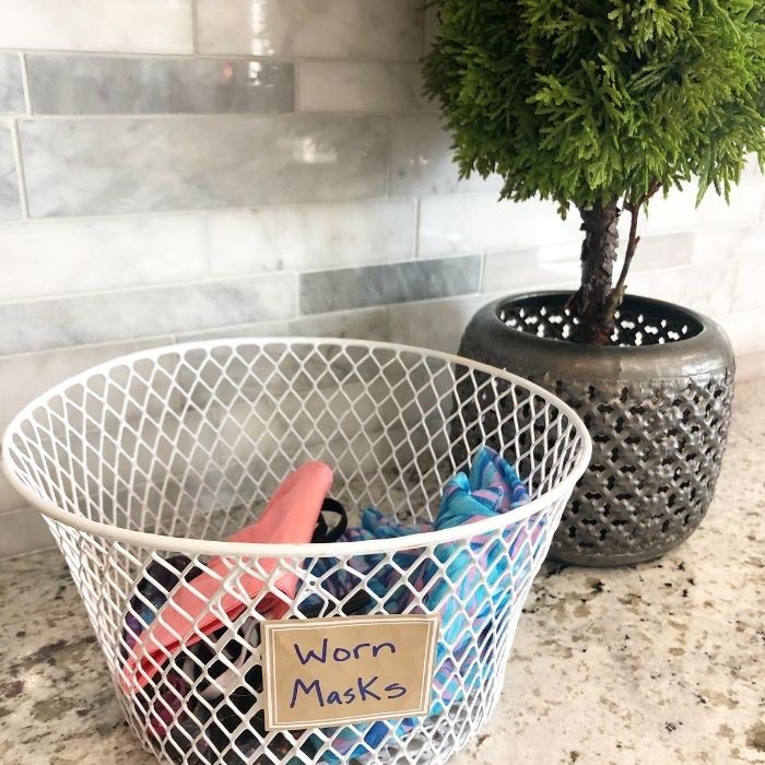 dirty mask in wire basket on counter