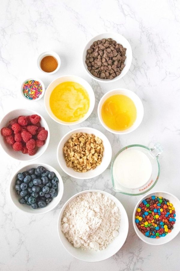 toppings for pancakes in bowls on counter