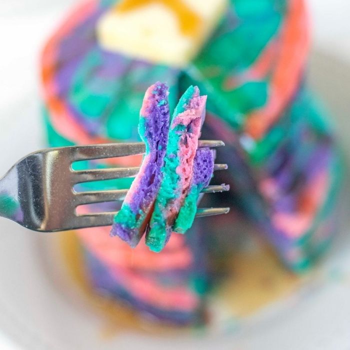 pancakes on a fork with stack behind it 