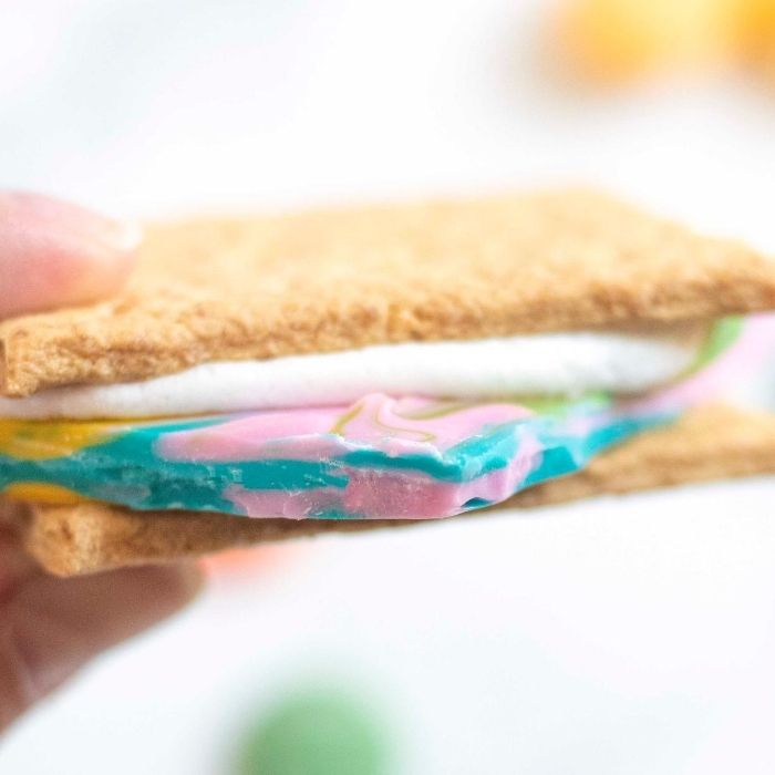 holding a colored smores 