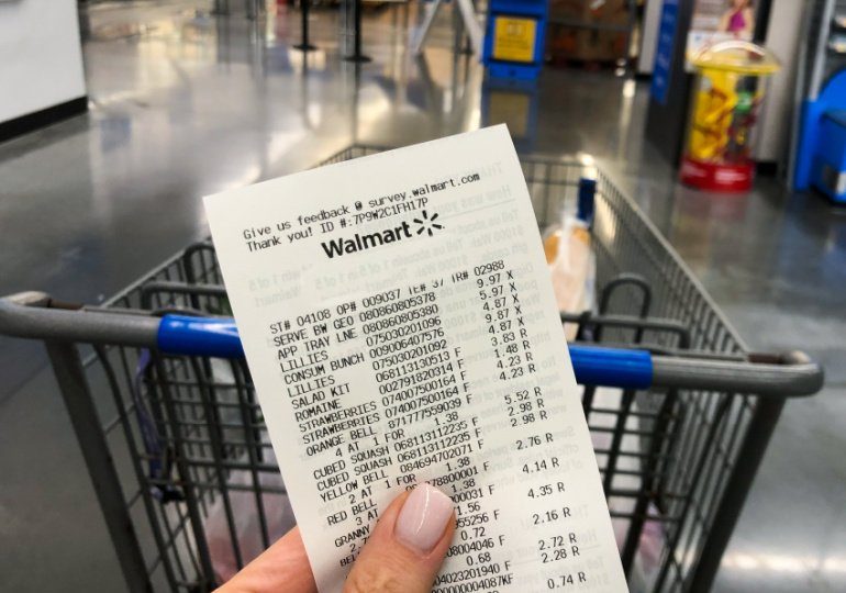 Walmart Savings Hacks - Holding a Walmart receipt