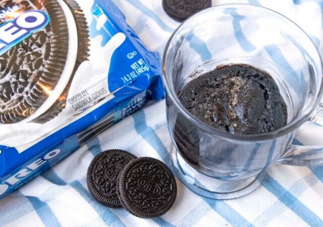 mug cake with Oreos and container by it on counter