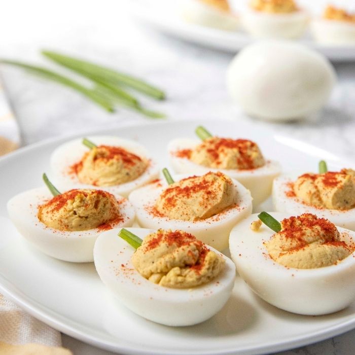 pumpkin deviled eggs on tray 