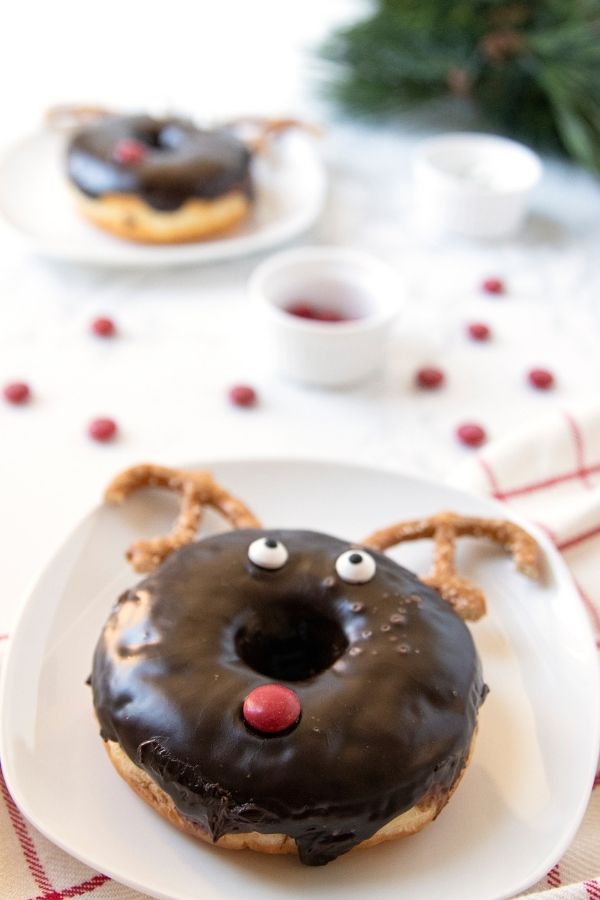 christmas breakfast donut on table with candies around it 