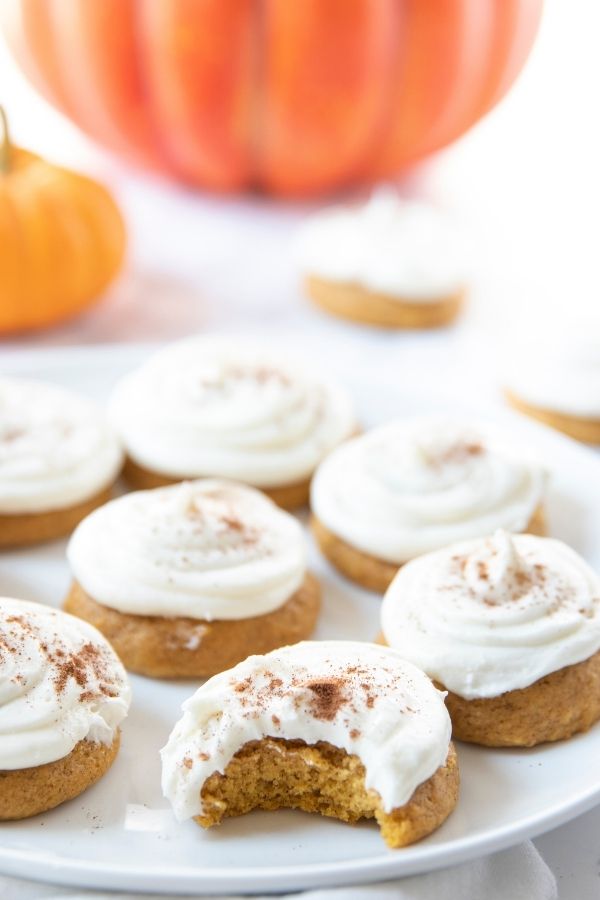 plate of cookies with bite taken out of it 