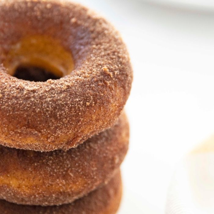 Cinnamon Sugar Pumpkin Donuts are the perfect fall donut recipe. Pumpkin spice donuts are one of my favorites to serve up. A baked donut recipe to enjoy. #donut #pumpkin #passion4savings #Pumpkinspice #donutrecipe #cinnamonsugar #coating #easy #best #oven #baked stacked donuts