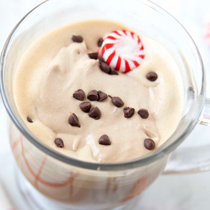 Dalgona Whipped Peppermint Mocha is one of my favorite winter drink recipes. A fun twist to a classic whipped Dalgona recipe. Mocha and peppermint unite. #passion4savings #mocha #peppermint #coffee #whipped #dalgona #holiday #popular #tiktok cup of mocha coffee with chocolate chips and peppermint on top