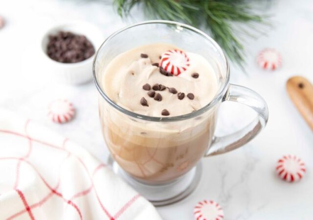 cup of peppermint mocha with peppermint candies and towel by it