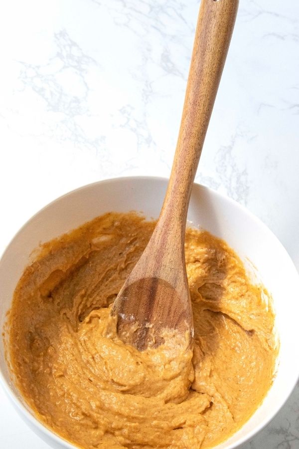 pumpkin donut batter in bowl with spoon